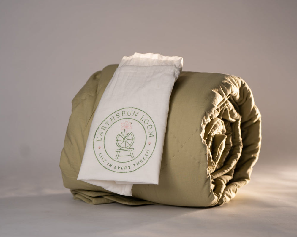 Folded organic cambric cotton comforter in natural green