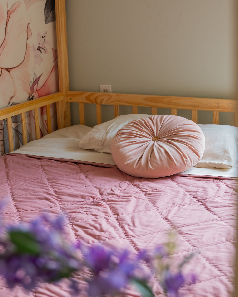 Organic cotton comforter styled on child’s bed for everyday use in a sweet mauve pink